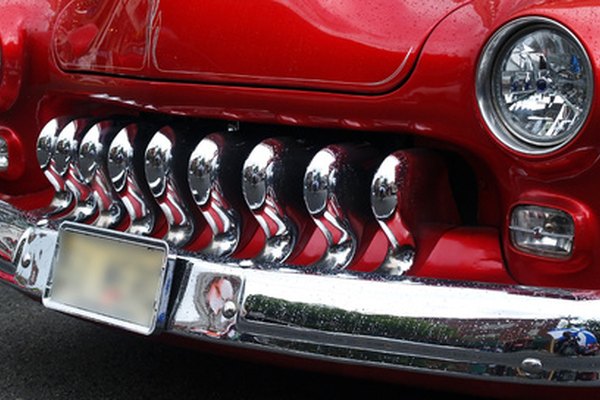a car in a car show image by Gary from Fotolia.com Front grill of old school car with blurred license plate