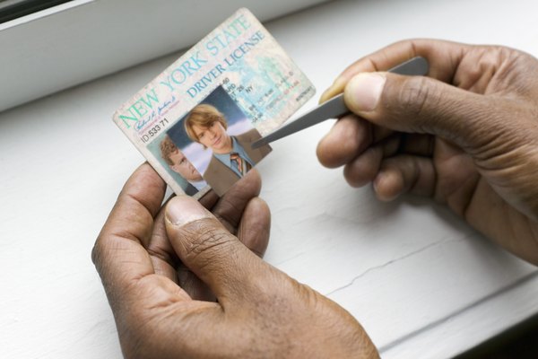 Creatas/Creatas/Getty Images Hands making fake ID