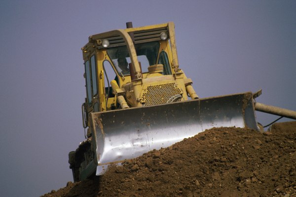 Stockbyte/Stockbyte/Getty Images Bulldozer pushing dirt