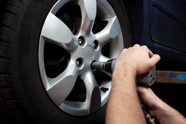 Bart?omiej Szewczyk/iStock/Getty Images Changing wheel on car